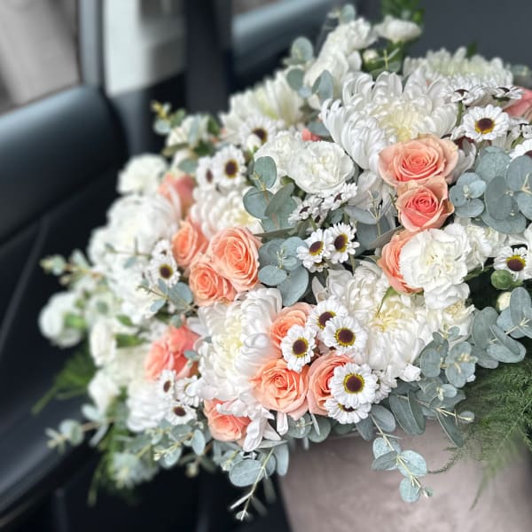 Bouquet of peach roses, white chrysanthemums, and small white daisies