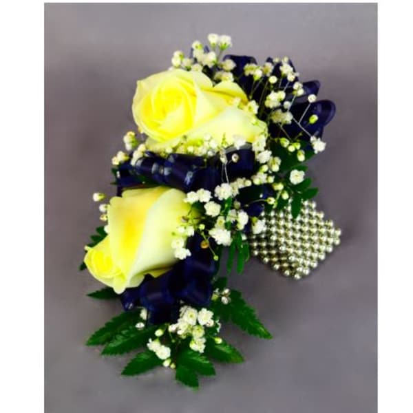 Yellow rose corsage with baby's breath, navy ribbon, and pearl accents