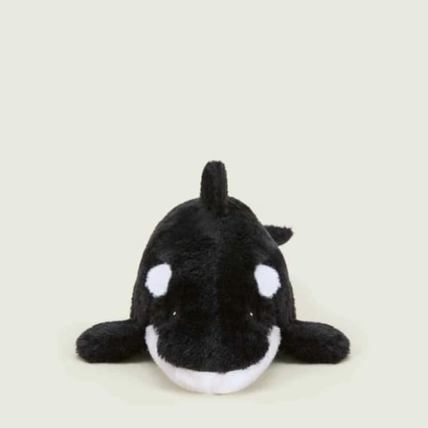 Black and white orca plush toy on a plain background