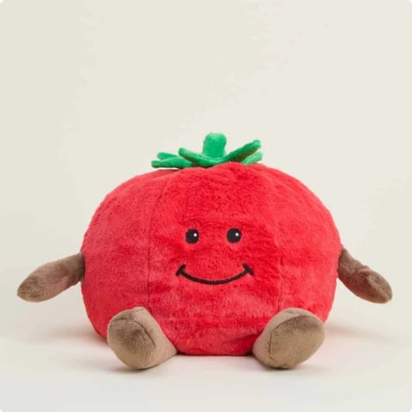 Plush tomato-shaped toy with a smiling face and small limbs