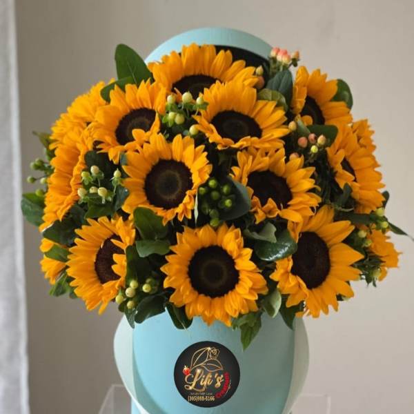 Bouquet of yellow sunflowers in a light blue hat box