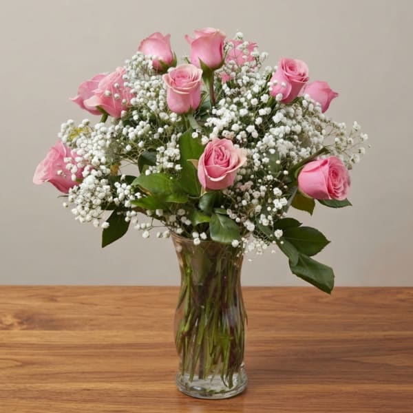 Pink roses and baby's breath in a clear glass vase