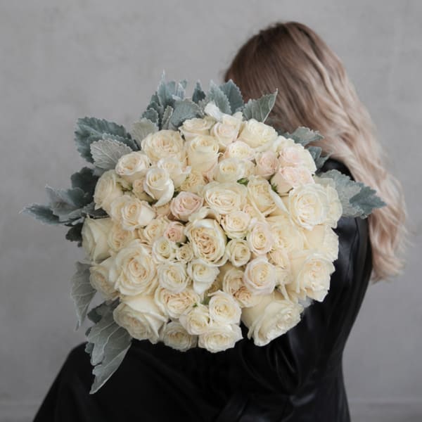 Large bouquet of cream roses with silvery foliage
