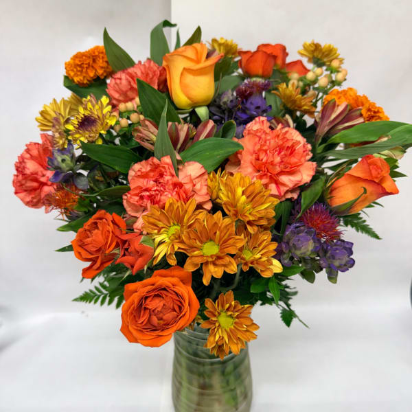 Orange and pink mixed bouquet in a glass vase