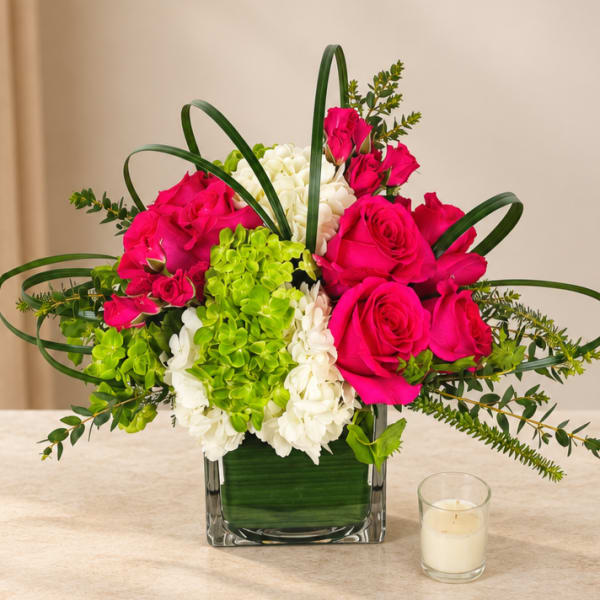 Pink roses and white hydrangeas in a square glass vase