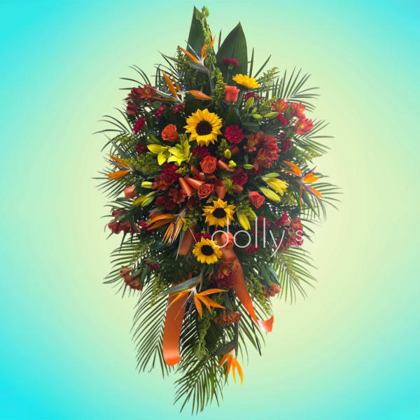 Large tropical floral spray with sunflowers, roses, and orange ribbon