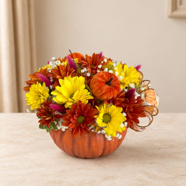 Autumn flower arrangement in a pumpkin-shaped container