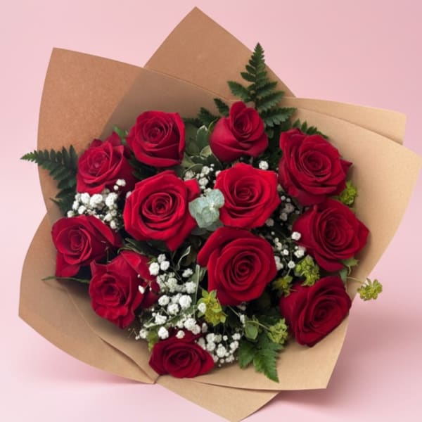 Bouquet of red roses wrapped in brown paper