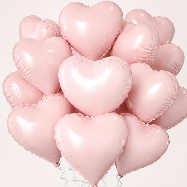 Cluster of pale pink heart-shaped balloons on a light background