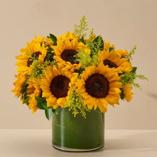 Sunflower bouquet in a green glass vase