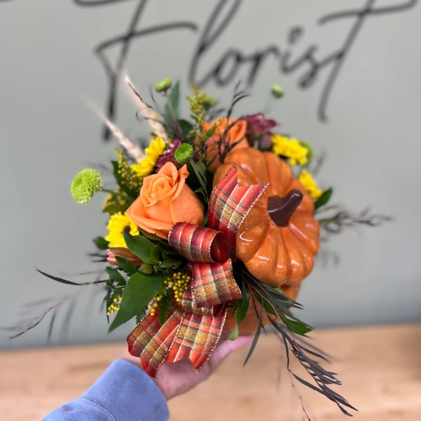 Orange rose bouquet with a small pumpkin and plaid ribbon