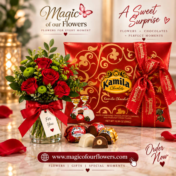 Red roses in a glass vase beside a red chocolate gift box