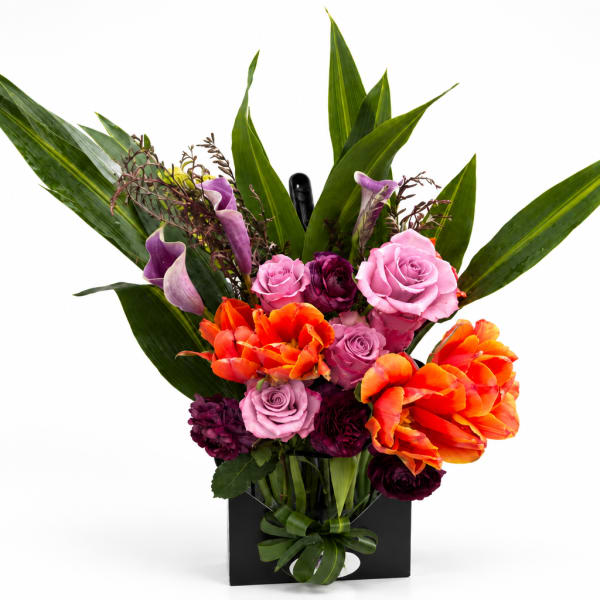 Bright mixed bouquet with roses, calla lilies, and orange tulips in a black box