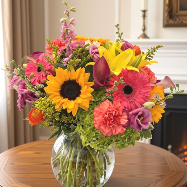 Colorful mixed bouquet in a clear glass vase on a table