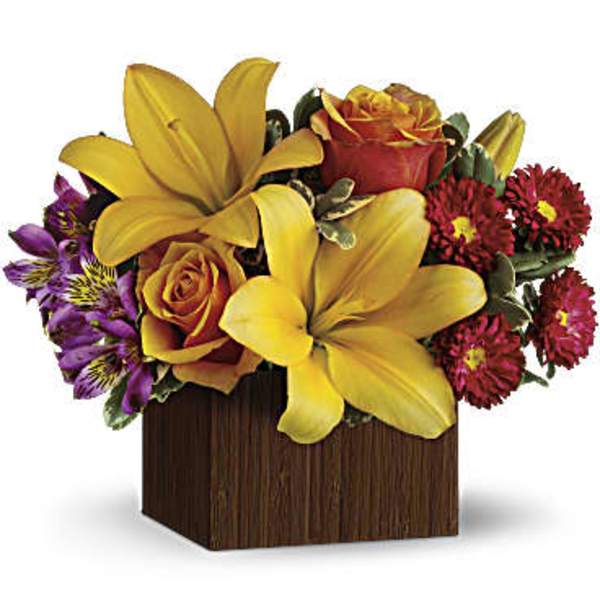 Yellow lilies and roses in a wooden cube vase with purple and red flowers