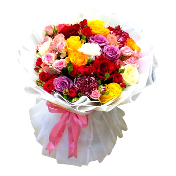 Bouquet of multicolored roses wrapped in white paper with a pink ribbon