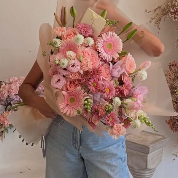 Pink mixed bouquet wrapped in translucent paper