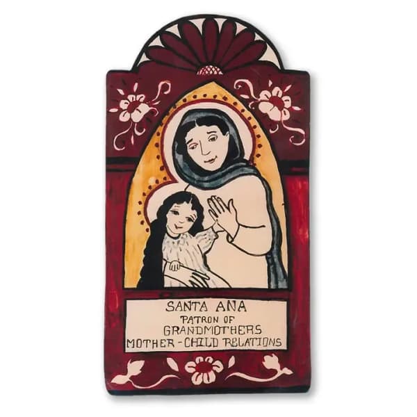 Folk-art style painted plaque with Santa Ana and child, framed by red floral motifs and text panel