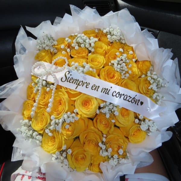 Bouquet of yellow roses with white baby's breath and a ribbon