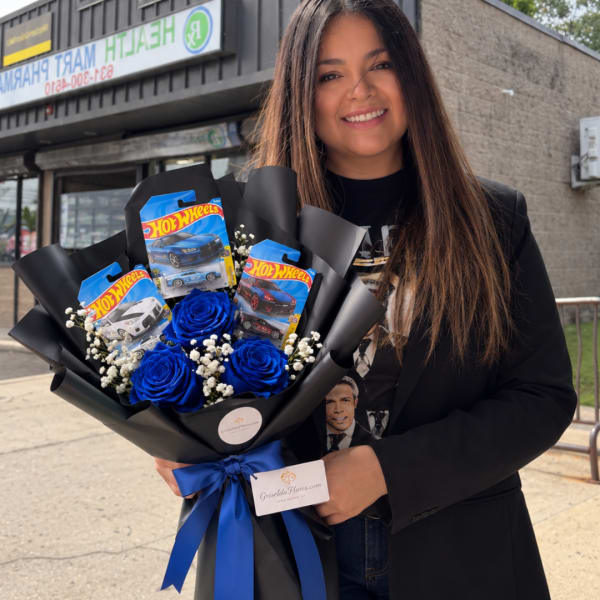 Woman holding a bouquet of blue roses and Hot Wheels packages