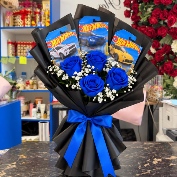 Bouquet of blue roses with Hot Wheels packages and a blue ribbon