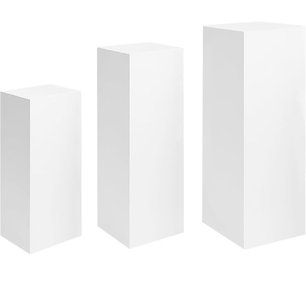 Three white pedestal stands of different heights on a white background