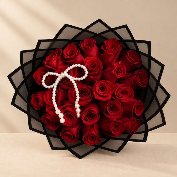 Bouquet of red roses wrapped in black paper with a pearl bow