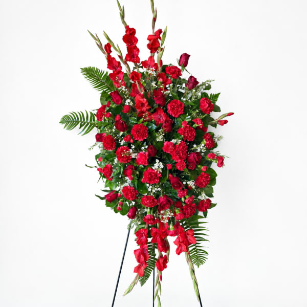 Tall red floral standing spray on a black easel