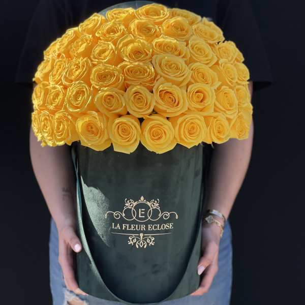 Large bouquet of yellow roses in a dark green box