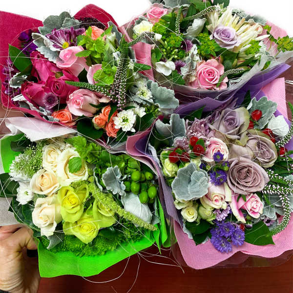 Assorted rose bouquets wrapped in colorful paper