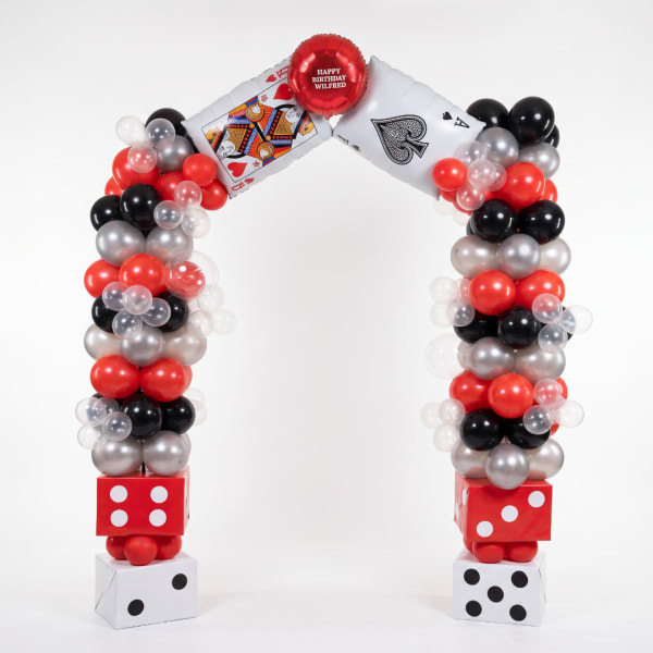 Balloon arch with playing card balloons and dice blocks