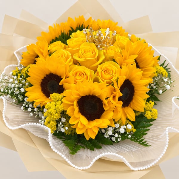 Bouquet of yellow roses and sunflowers with a small crown topper
