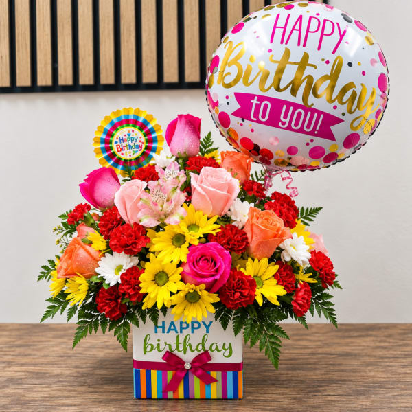 Birthday flower arrangement with roses, daisies, and balloons in a gift box