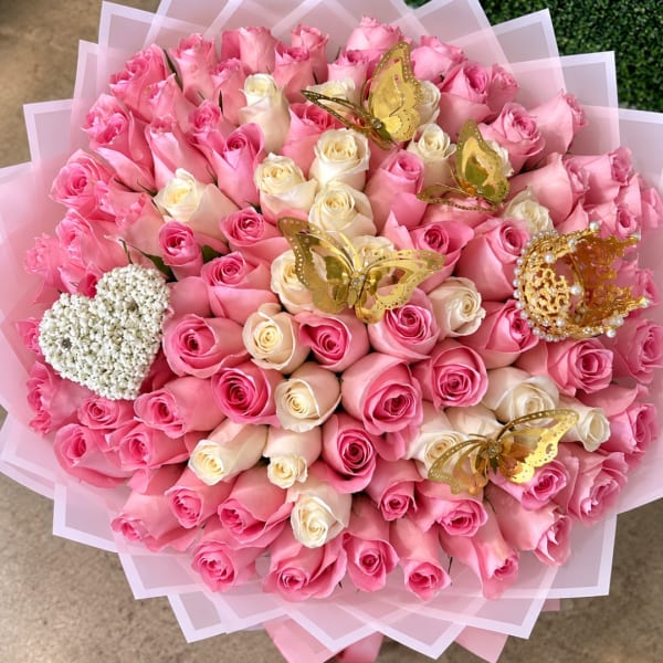 Large bouquet of pink and cream roses with gold butterfly decorations