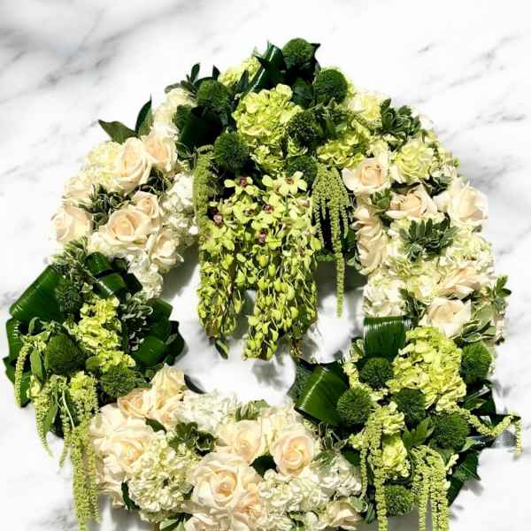 Floral wreath with cream roses and green hydrangeas on a white background