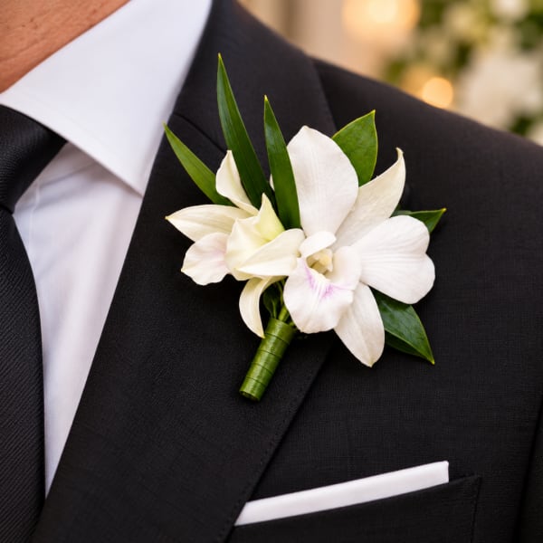 White orchid boutonniere on a black suit jacket