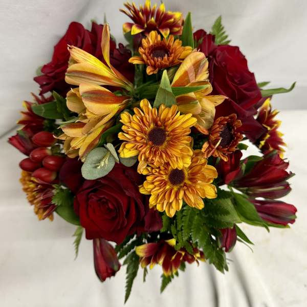 Bouquet of red roses and yellow-orange daisies on a white background