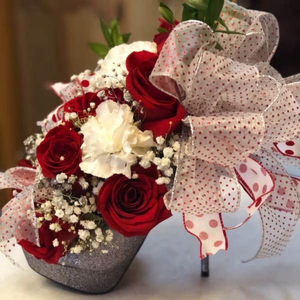 Red and white rose bouquet with a large polka-dot ribbon