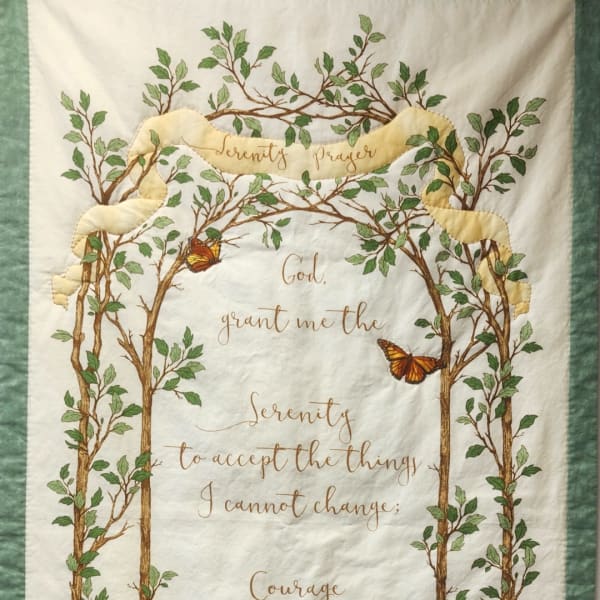 Quilt with tree branches, butterflies, and a serenity prayer quote