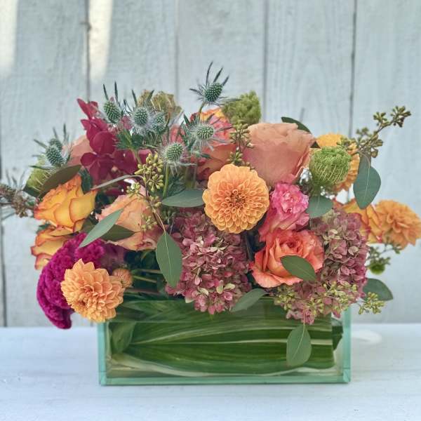 Colorful mixed bouquet in a rectangular glass vase