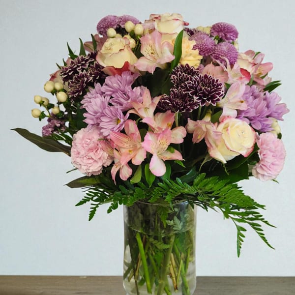 Mixed pink and purple bouquet in a clear glass vase