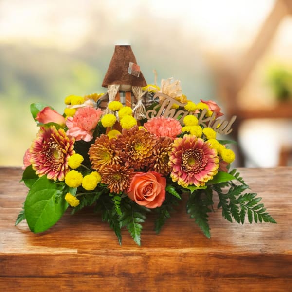 Autumn floral arrangement with orange roses, mums, and yellow pom-poms