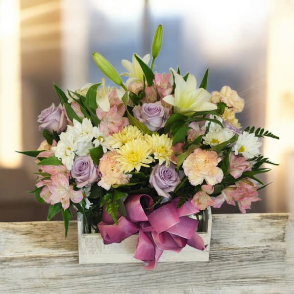 Mixed bouquet in a white wooden box with a purple ribbon