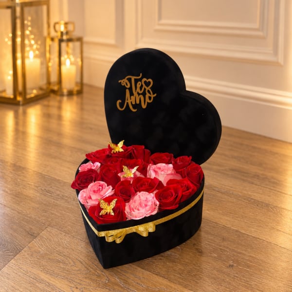 Heart-shaped box of red and pink roses with gold butterfly accents