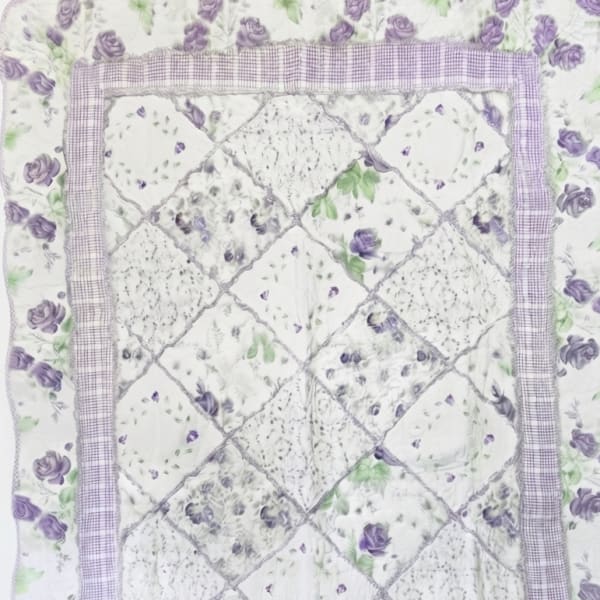 Quilt with purple rose floral print and patchwork center panel