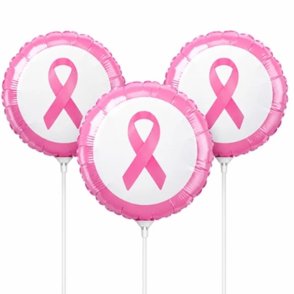 Three pink ribbon balloons on sticks against a white background