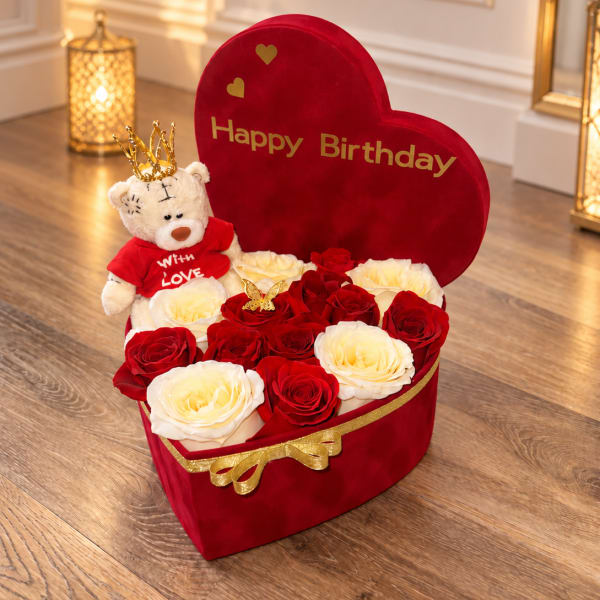 Heart-shaped birthday gift box with red and white roses and a teddy bear