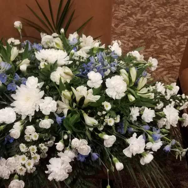 Large white and blue floral spray arranged on the floor