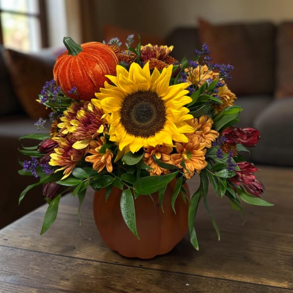 Sunflower and chrysanthemum arrangement in a pumpkin vase