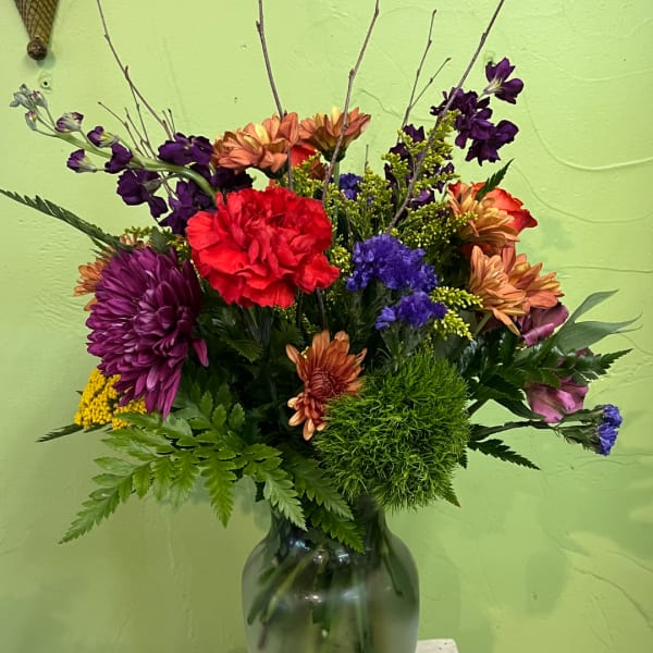 Colorful mixed flower arrangement in a glass vase